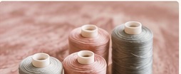 Thread spools on blush fabric